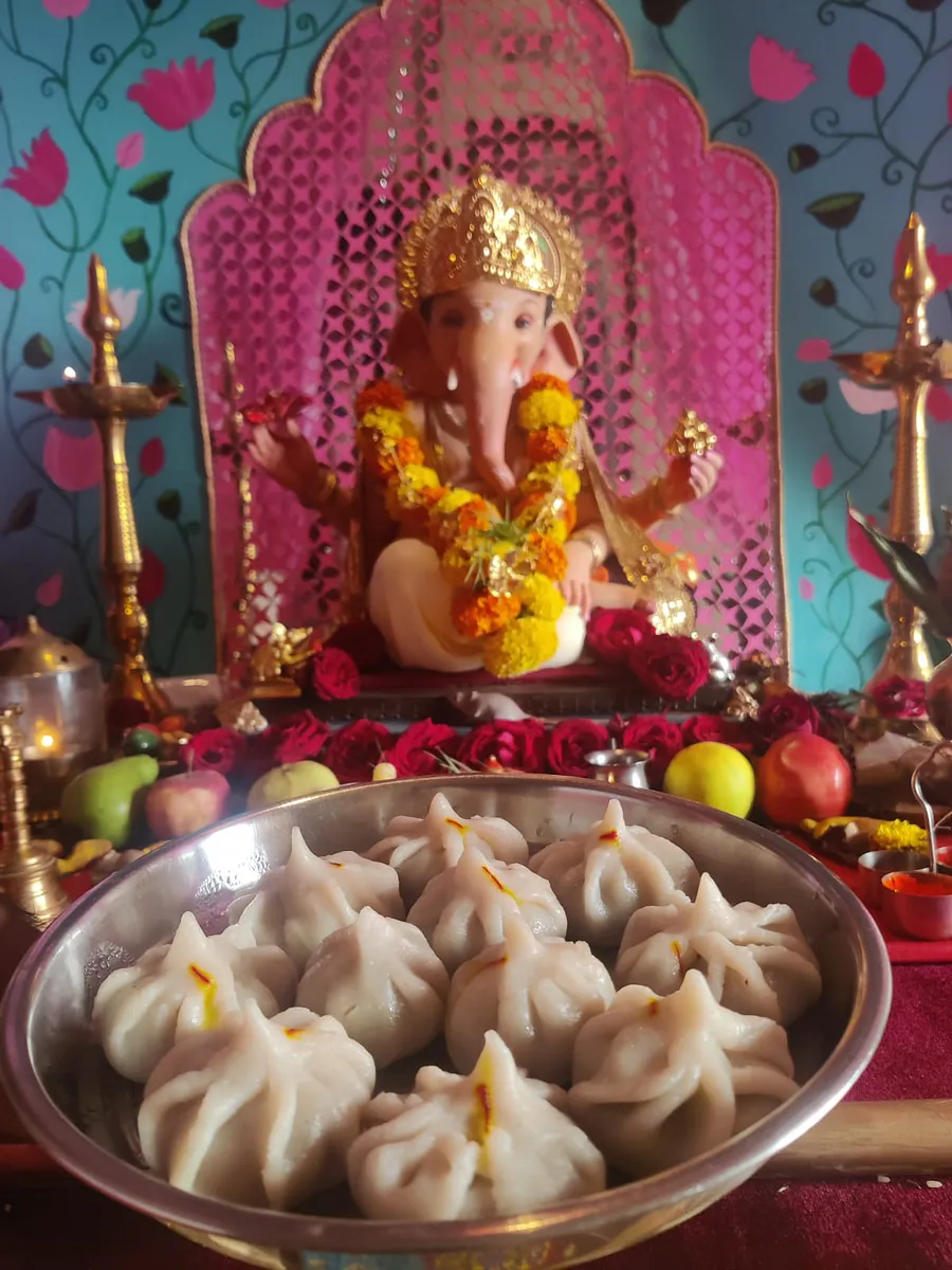Ganesh idol with a plate of freshly made ukdiche modak offered as prasad