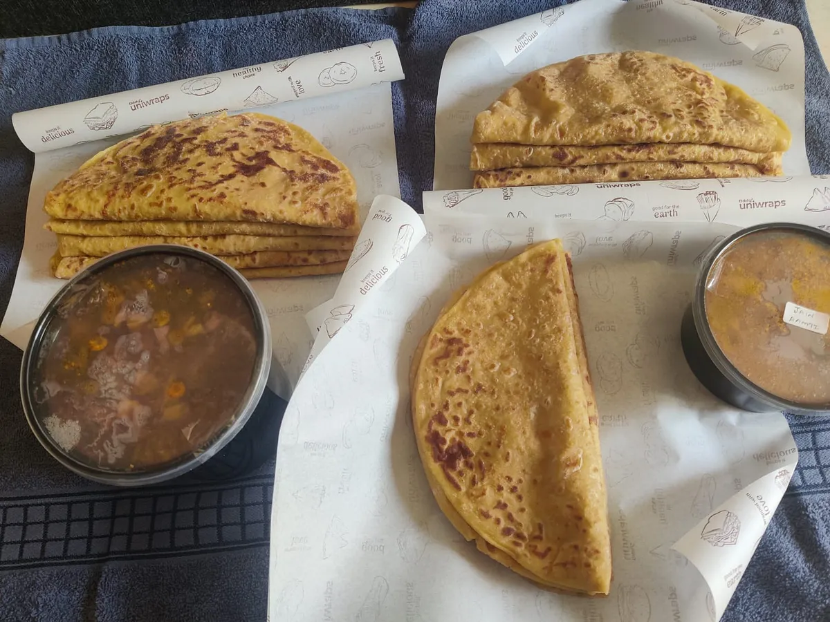 Stacks of puranpoli with bowls of katachi aamti